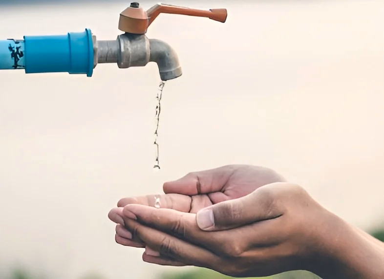 Children gathering clean water at a village water tank