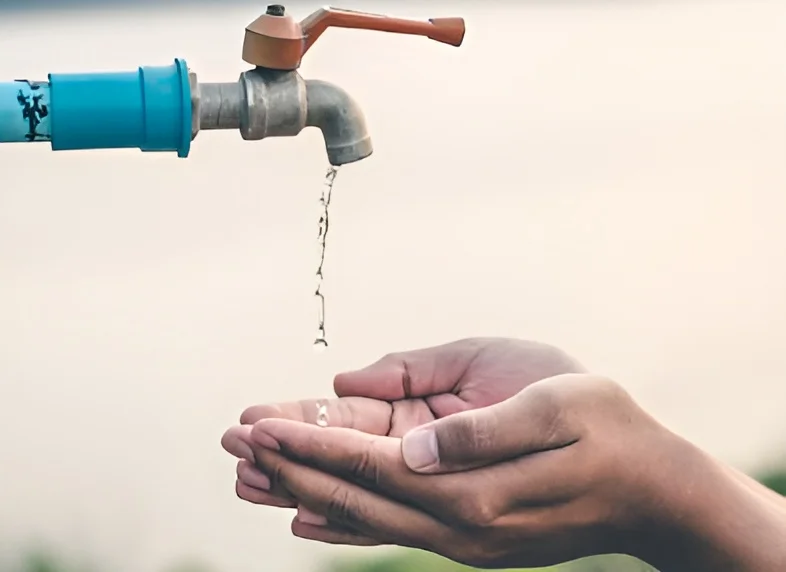 Children gathering clean water at a village water tank